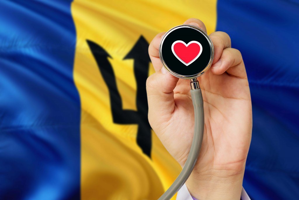 Doctor holding stethoscope with red love heart with National Barbados flag background - MBBS in Barbados